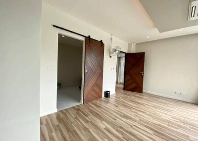 Spacious living room with wooden flooring and sliding barn doors