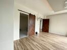 Spacious living room with wooden flooring and sliding barn doors