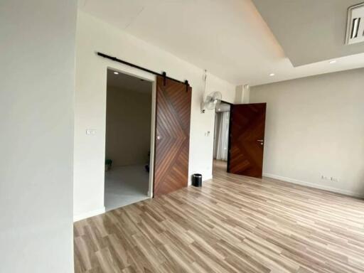 Spacious living room with wooden flooring and sliding barn doors