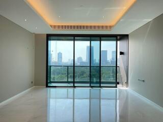 Spacious living room with large windows and city view