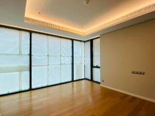 Modern living room with large windows and recessed lighting