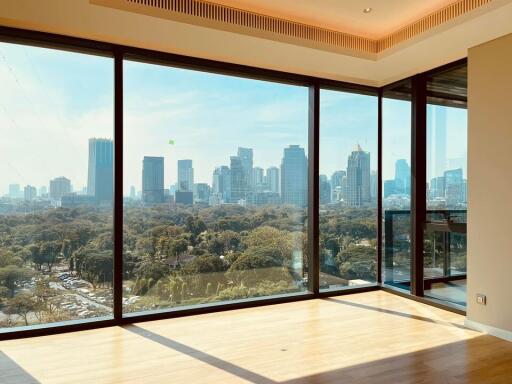 Spacious living room with large windows and city view