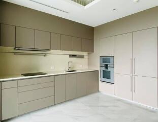 Modern kitchen with built-in appliances and sleek cabinetry