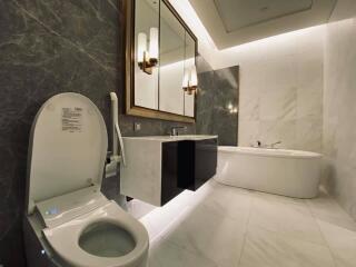 Modern bathroom with marble tiles and sleek fixtures