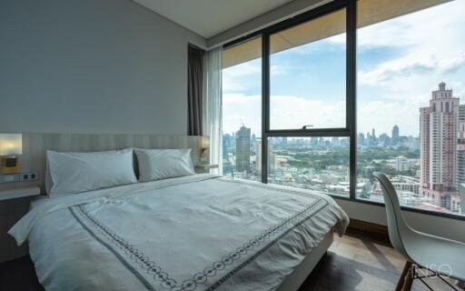 Bedroom with a large window and city view