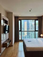 Bedroom with large window and city view