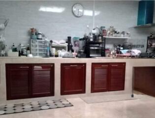 Spacious kitchen with wooden cabinets and countertops