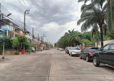 Quiet residential street with parked cars