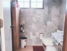 Modern bathroom with tiled walls and natural light