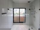 Modern bathroom with glass shower enclosure and city view