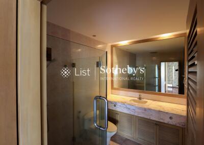 Modern bathroom with glass shower and large mirror