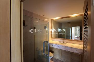 Modern bathroom with glass shower and large mirror