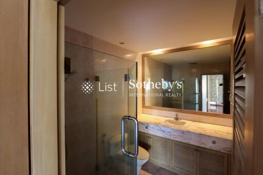 Modern bathroom with glass shower and large mirror