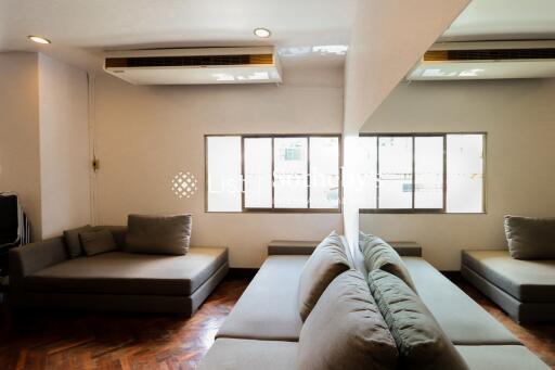 Spacious living room with sectional sofas and large window