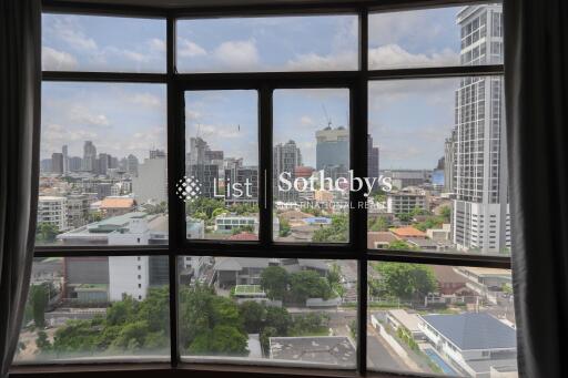 View through large windows showing a cityscape