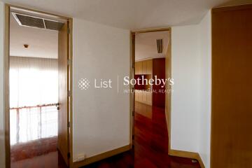 Open door view into another room with wooden flooring