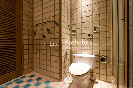 Bathroom with tiled walls and toilet