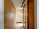 Hallway with wooden doors and marble floor