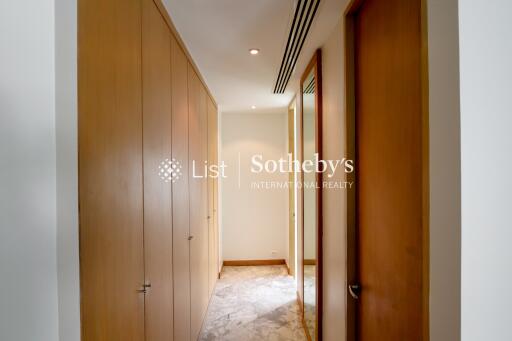 Hallway with wooden doors and marble floor