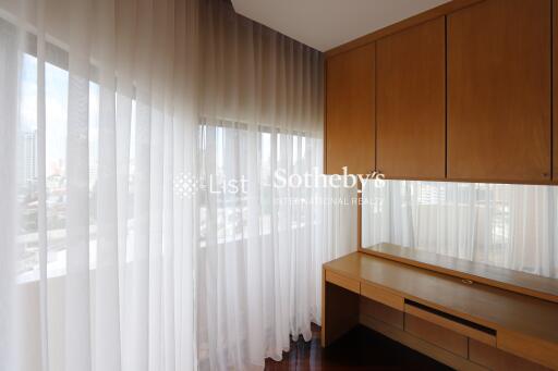 Bedroom with large windows and built-in wooden furniture