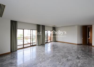 Spacious main living area with large windows and balcony access