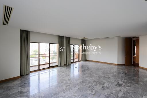 Spacious main living area with large windows and balcony access