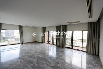 Spacious living room with marble flooring and large windows