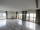 Spacious living room with marble flooring and large windows