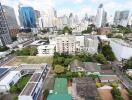 Aerial view of a cityscape with various buildings and greenery