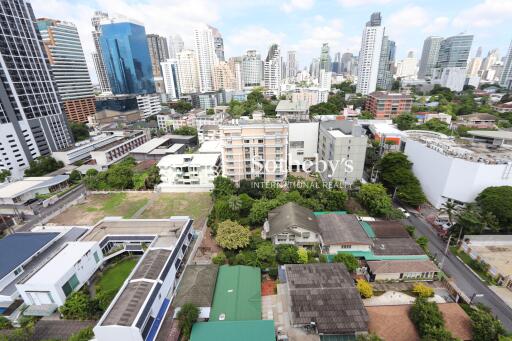 Aerial view of a cityscape with various buildings and greenery