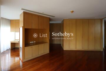 Spacious living room with wooden cabinets and hardwood flooring