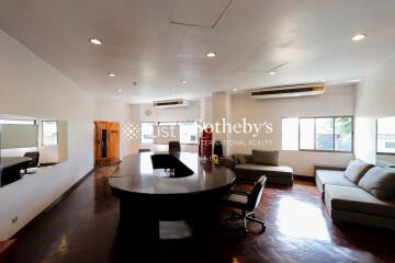 Spacious living room with modern furniture and a central wooden table