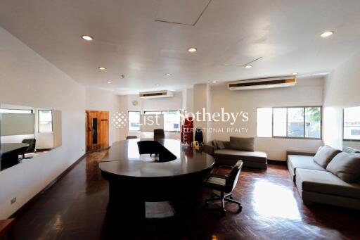 Spacious living room with modern furniture and a central wooden table