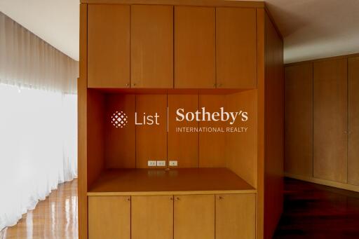 Spacious room with built-in wooden storage cabinets