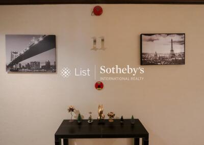 Hallway with wall decor and a small table