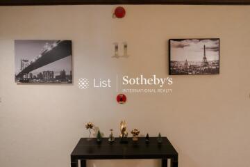 Hallway with wall decor and a small table