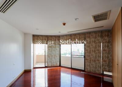 Spacious living room with large windows and wooden flooring