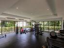 Spacious and well-equipped gym with modern fitness equipment and large windows