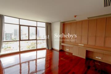 Bright and spacious living room with large windows and built-in cabinetry