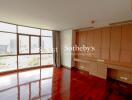 Bright and spacious living room with large windows and built-in cabinetry