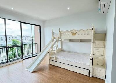 Spacious bedroom with slide bunk bed and large windows