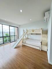 Spacious bedroom with slide bunk bed and large windows