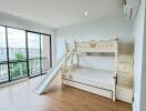 Spacious bedroom with slide bunk bed and large windows