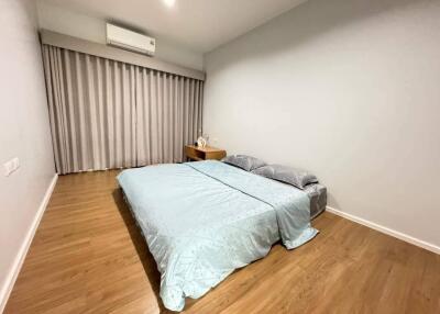 Minimalist bedroom with wooden floor