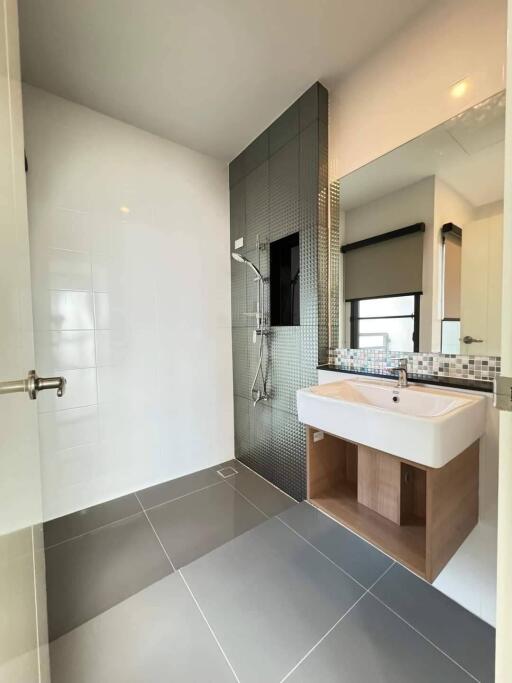 Modern bathroom with sink and shower area