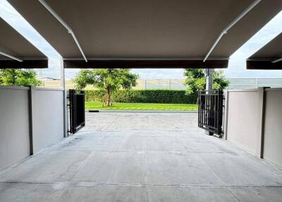 View from inside a garage with open doors leading to the outside