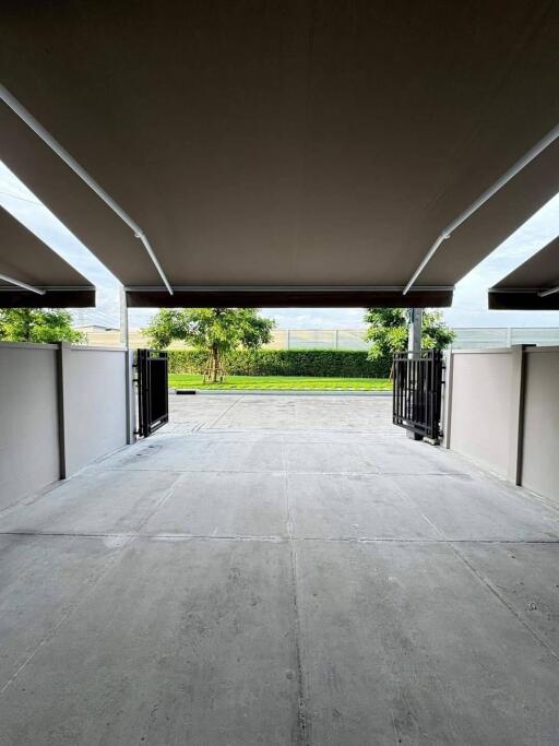 View from inside a garage with open doors leading to the outside