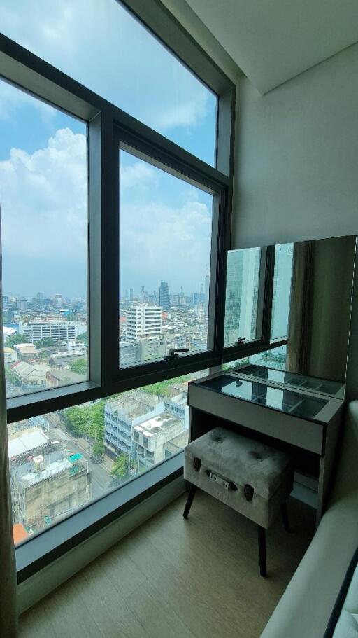 Cozy bedroom with vanity corner and large window view