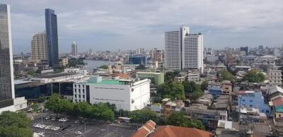 City skyline view with multiple buildings including a river in the background