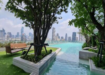 Outdoor pool area with city skyline view